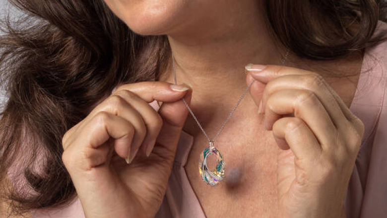 Shimmering Sea Crystal Pendant held in a woman's hand