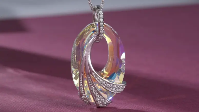 Shimmering Sea Crystal Pendant displayed against a magenta background